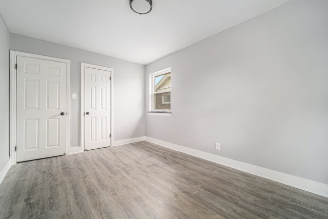 16140 Monte Vista St, Detroit, MI 48221 - unfurnished bedroom featuring baseboards, wood finished floors, and a closet