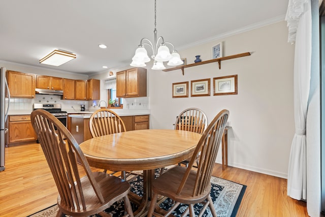 dining space with crown molding, an inviting chandelier, light wood-style floors, recessed lighting, and baseboards