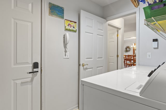 clothes washing area with washer and dryer and laundry area