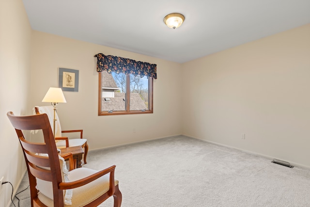 living area featuring carpet floors, baseboards, and visible vents