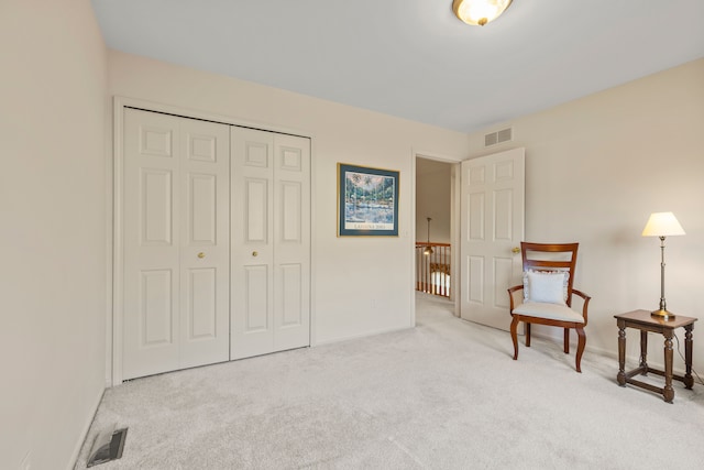 living area with carpet flooring, baseboards, and visible vents