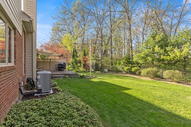 view of yard with a patio, a fenced backyard, and central AC