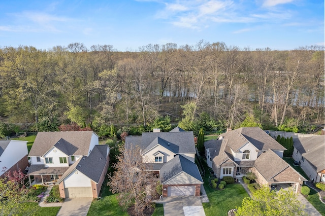aerial view featuring a view of trees and a residential view