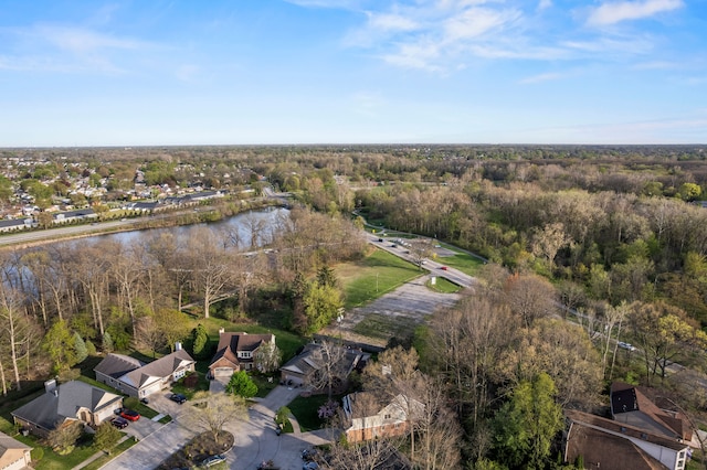 drone / aerial view with a water view, a residential view, and a wooded view