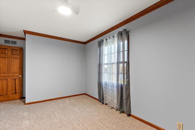 empty room with baseboards, ornamental molding, and visible vents