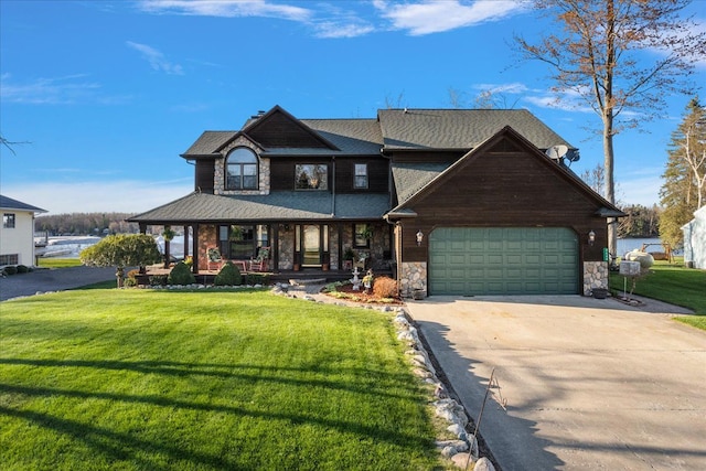 craftsman-style home with a porch, a front yard, concrete driveway, an attached garage, and stone siding