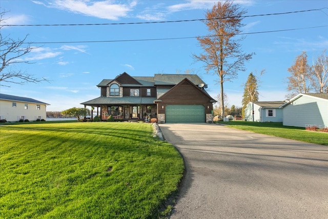 view of front of home with a porch, aphalt driveway, stone siding, and a front lawn