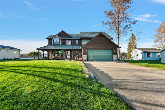 view of front of property featuring covered porch, a front yard, concrete driveway, and stone siding