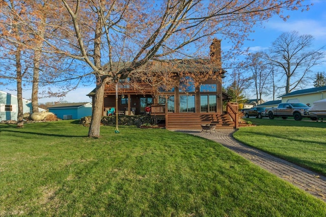 back of property with a lawn and a chimney