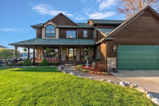 craftsman-style house with an attached garage, a front lawn, stone siding, covered porch, and driveway