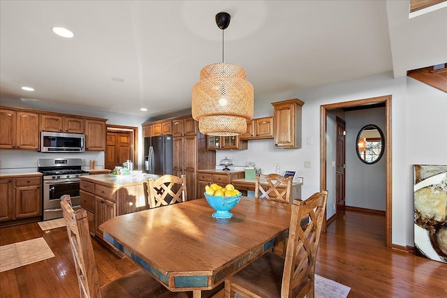 dining space with baseboards, recessed lighting, and dark wood-type flooring
