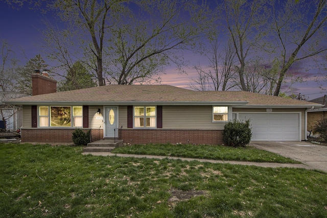 ranch-style house featuring a chimney, a front yard, brick siding, concrete driveway, and an attached garage