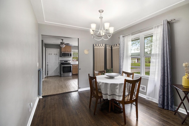dining area featuring dark wood-type flooring, baseboards, and a wealth of natural light