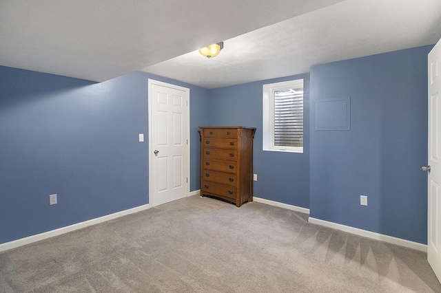 empty room featuring baseboards and carpet