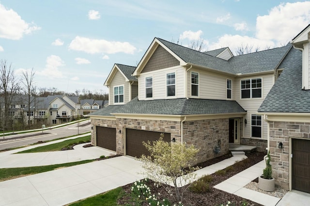 view of front of home with concrete driveway, a residential view, stone siding, roof with shingles, and an attached garage
