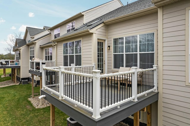 wooden terrace with a lawn