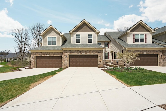 craftsman inspired home featuring concrete driveway, a front yard, and a garage