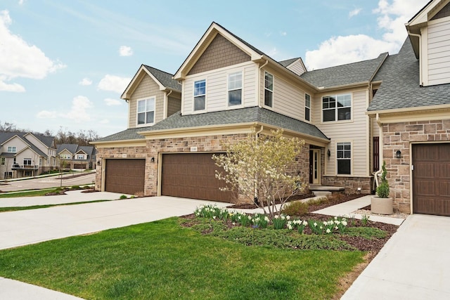 craftsman-style home featuring a front yard, driveway, stone siding, roof with shingles, and an attached garage