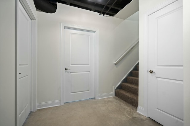stairway with baseboards and carpet flooring