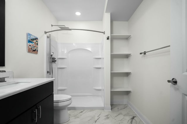 bathroom featuring toilet, a stall shower, marble finish floor, and vanity