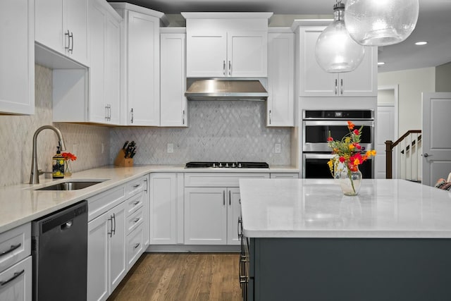 kitchen with stainless steel double oven, under cabinet range hood, dishwasher, a sink, and stovetop