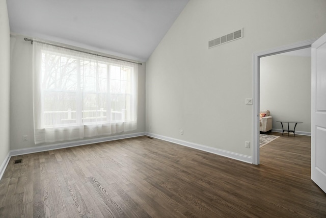 empty room featuring visible vents, dark wood finished floors, and baseboards