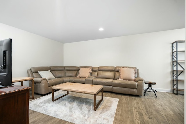 living area with light wood finished floors and baseboards