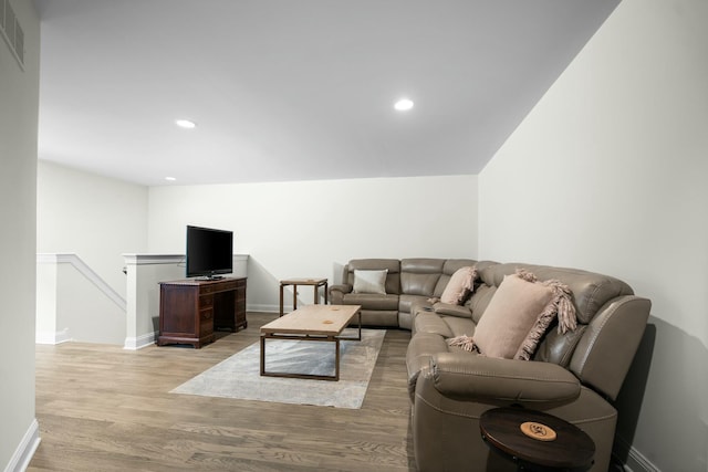living area featuring wood finished floors, recessed lighting, and baseboards