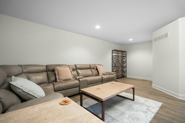 living room with wood finished floors, visible vents, recessed lighting, and baseboards
