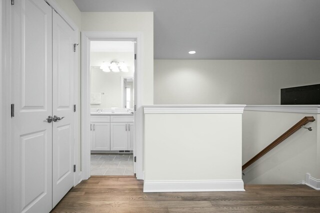 hallway featuring wood finished floors and recessed lighting
