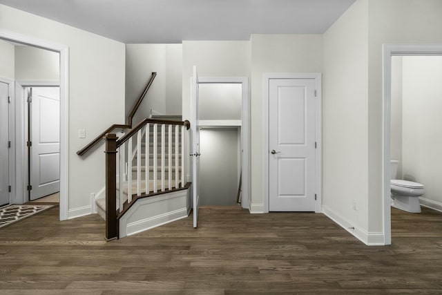 staircase with wood finished floors and baseboards