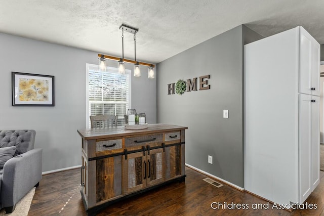 dining area with baseboards, dark wood-style flooring, a textured ceiling, and visible vents