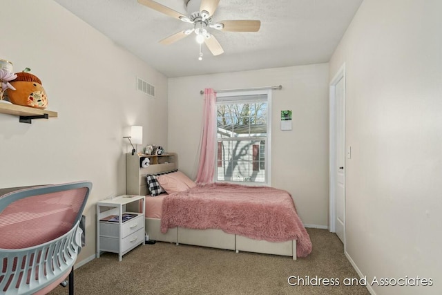 carpeted bedroom featuring visible vents, a ceiling fan, and baseboards