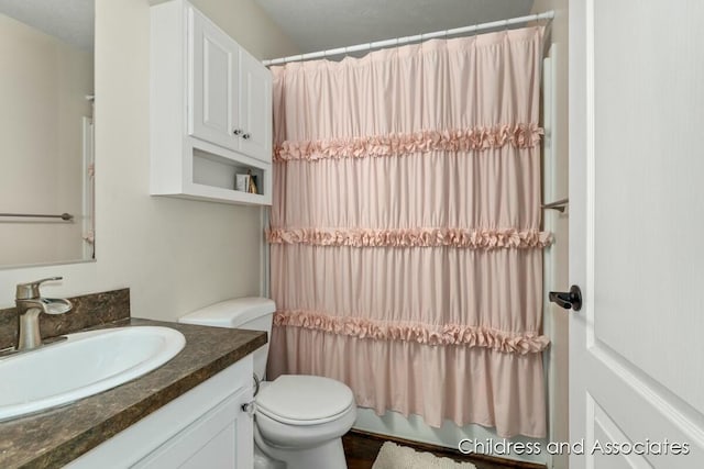 full bath featuring toilet and vanity