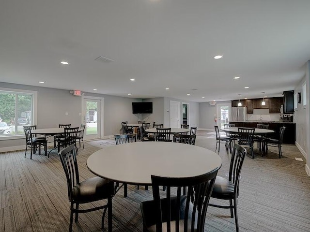 dining room featuring baseboards, plenty of natural light, and recessed lighting