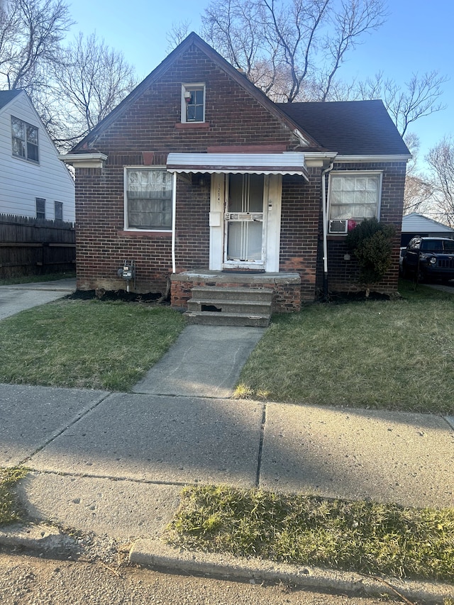 12541 Camden St, Detroit, MI 48213 - bungalow-style home featuring brick siding, a front lawn, and fence