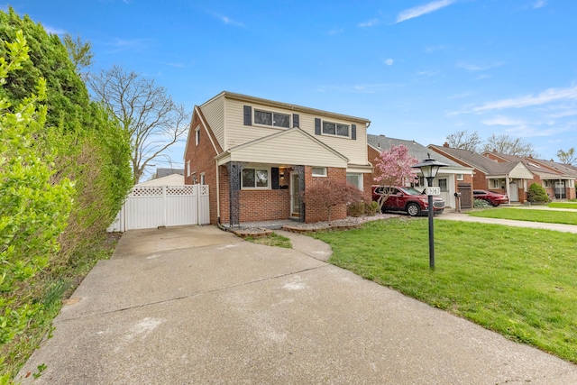 15167 Keppen Ave, Allen Park, MI 48101 - view of front of house with fence, a front yard, brick siding, a gate, and driveway