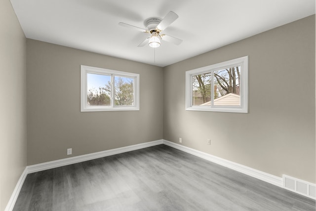 15167 Keppen Ave, Allen Park, MI 48101 - spare room with a healthy amount of sunlight, a ceiling fan, wood finished floors, and visible vents