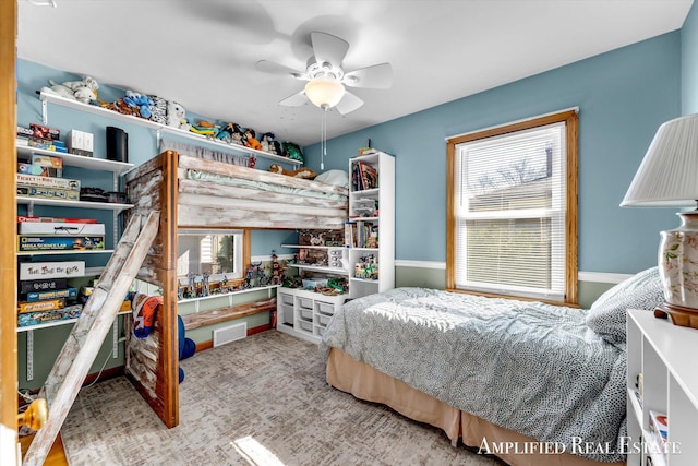 carpeted bedroom featuring visible vents and a ceiling fan