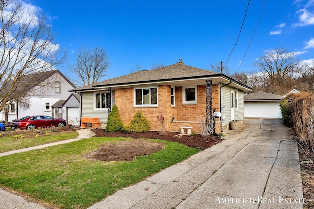 exterior space featuring a shingled roof, an outbuilding, a yard, brick siding, and a garage