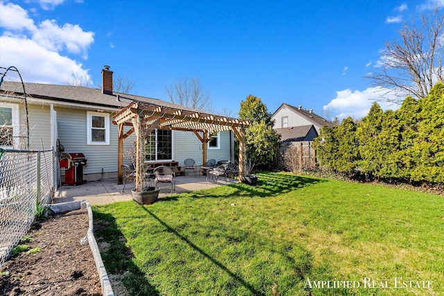 back of property with a patio, a chimney, a pergola, a yard, and a fenced backyard
