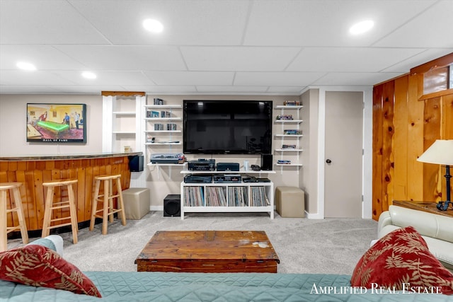 living room featuring baseboards, recessed lighting, a bar, and carpet flooring