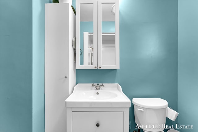 bathroom featuring toilet and vanity