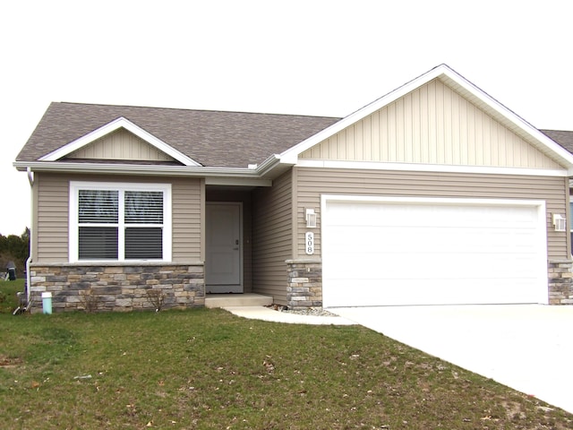view of front of property with a shingled roof, an attached garage, and stone siding