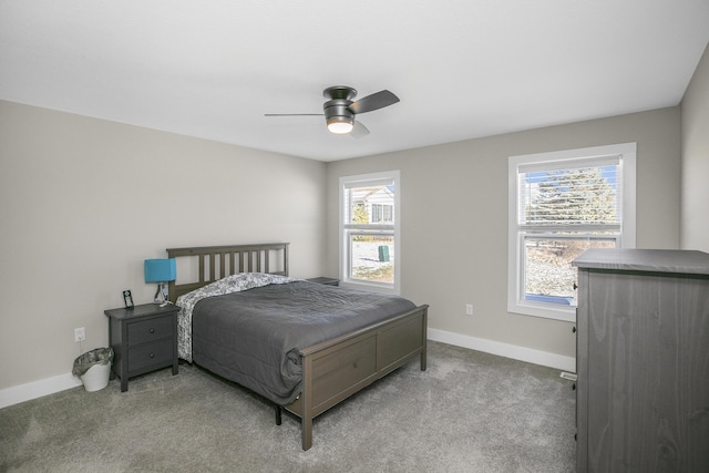 carpeted bedroom featuring baseboards and a ceiling fan