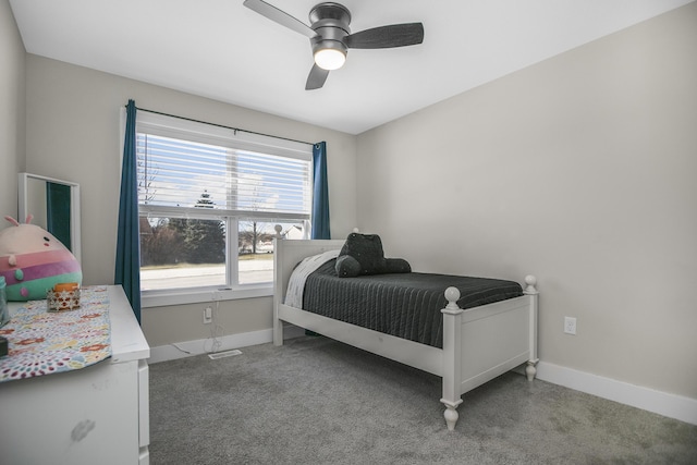 carpeted bedroom with a ceiling fan and baseboards