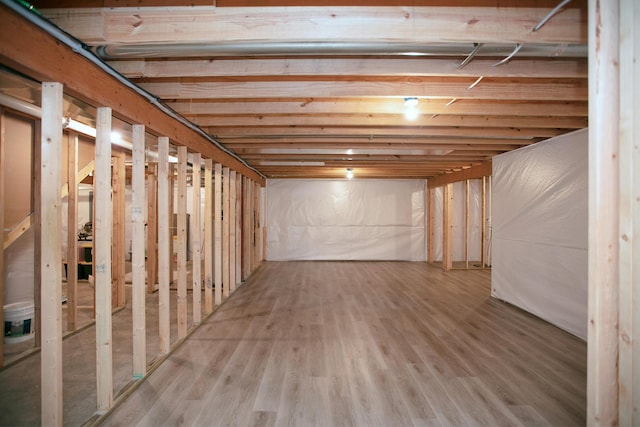 unfinished below grade area featuring wood finished floors