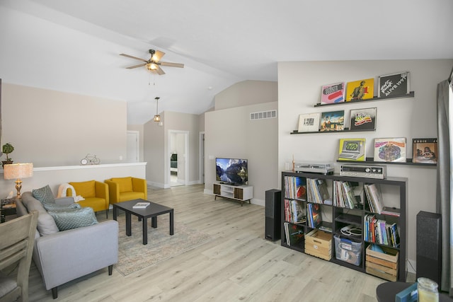 living room with visible vents, wood finished floors, ceiling fan, and lofted ceiling
