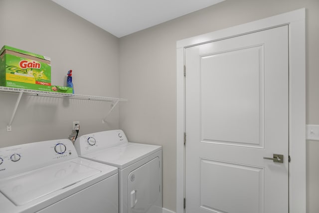 washroom with separate washer and dryer and laundry area