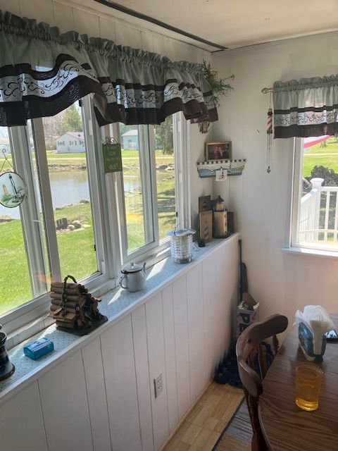 dining area with wood finished floors and a water view